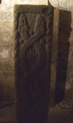 Carved stone in the crypt of St Mart's Lastingham, showing two serpents intertwined