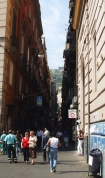 A view of the hills around Naples down the apex of a city street