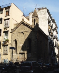 A fourteenth-century church slowly mouldering between more modern buildings on a Naples street
