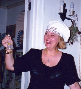 Picture of interior designer and cookery book writer Valentina Cirasola wearing a hat marked "dux coquorum", roughly "head cook", borrowed from her website