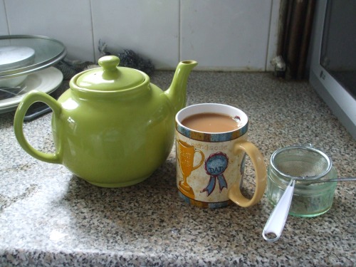 Teapot, mug and strainer in my kitchen