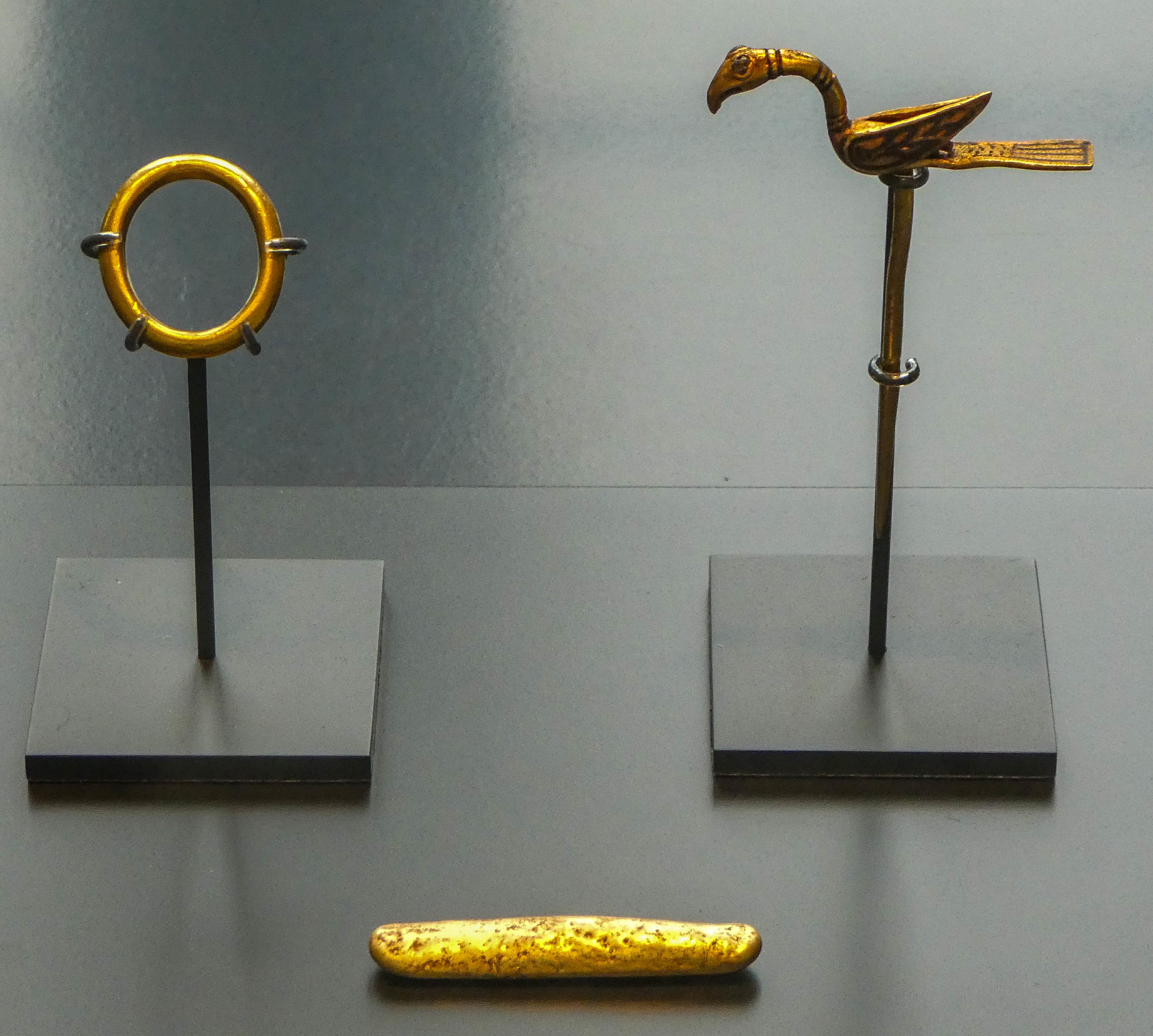 Three gold objects recovered from within a bundle of silver arm-rings in the Galloway Hoard in the National Museum of Scotland