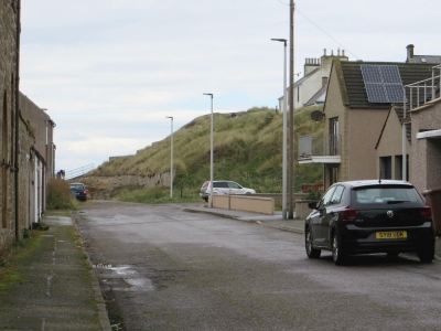 View of the remains of the Burghead hillfort from the approach street