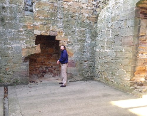 Historian Jonathan Jarrett standing by the remains of the ground-floor fireplace of the Marmion Tower