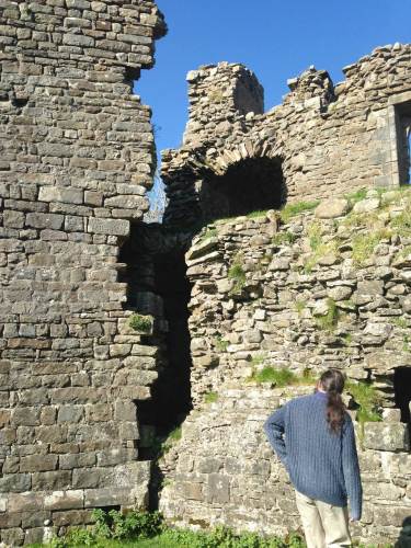Historian Jonathan Jarrett inspecting ruins at Pendragon Castle
